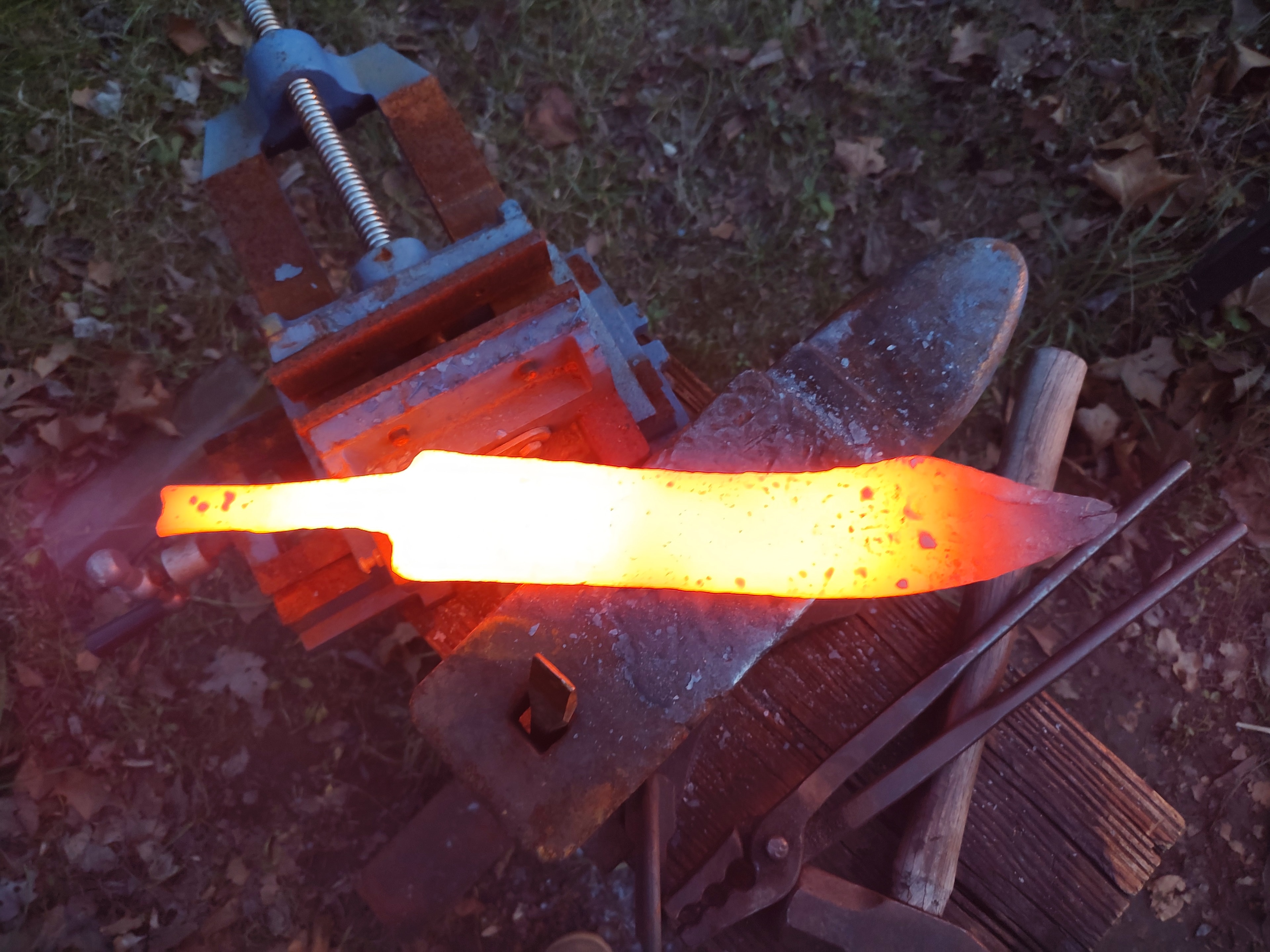 Glowing knife blade forged on the anvil