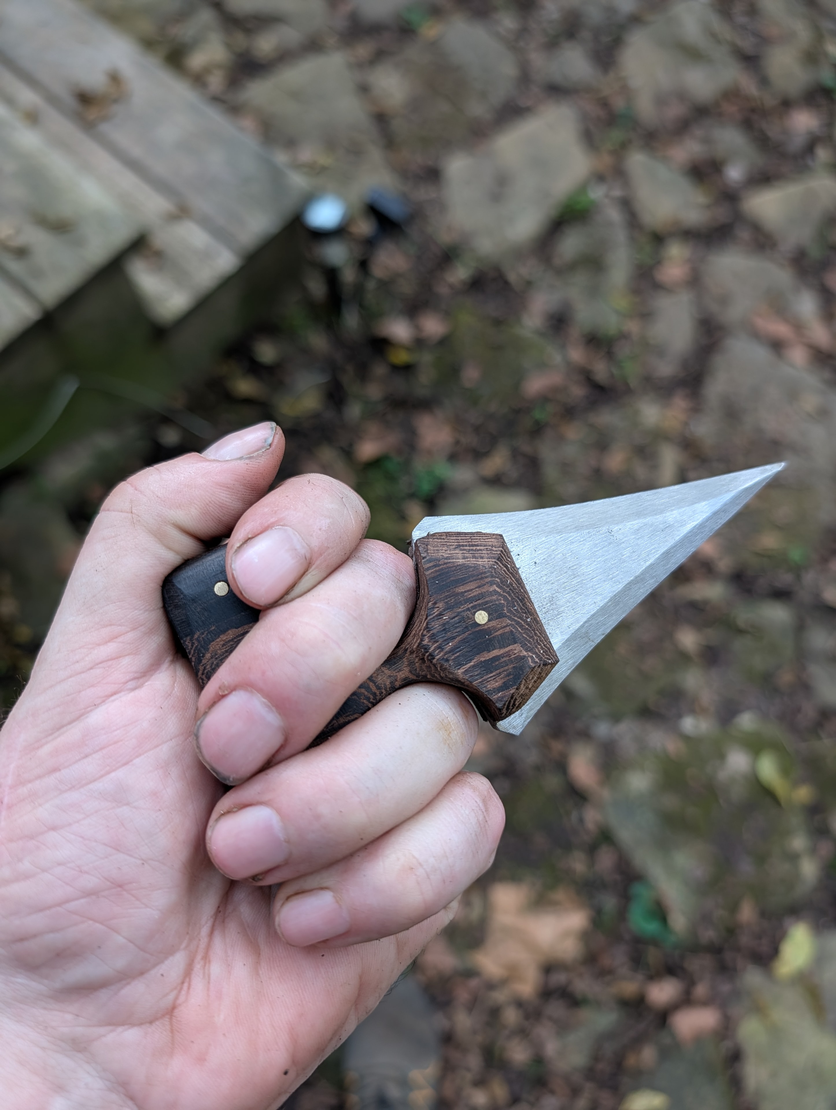 Push dagger with wenge handle gripped in fist