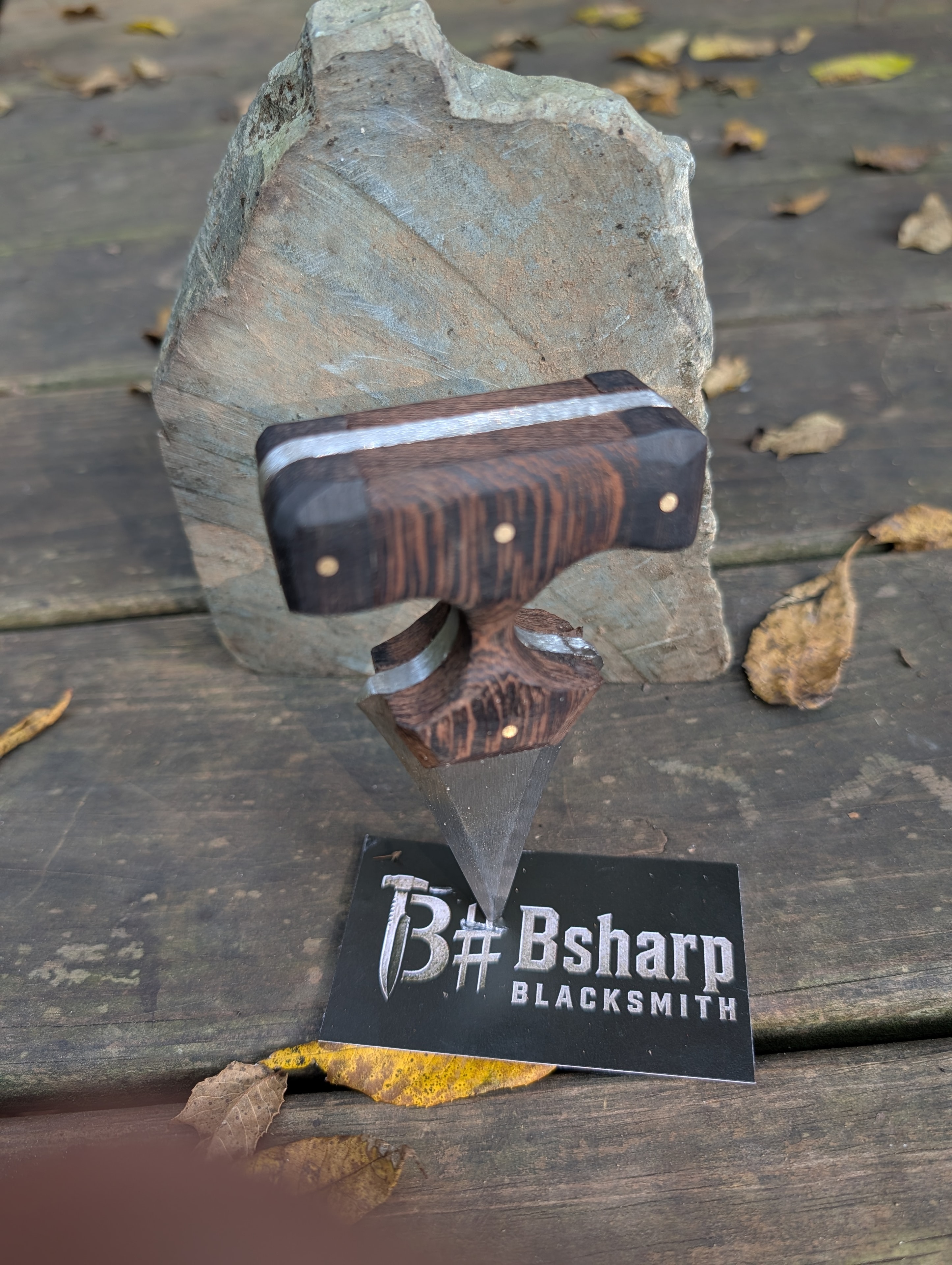 Double-guard push dagger balanced on stone with Bsharp Blacksmith card