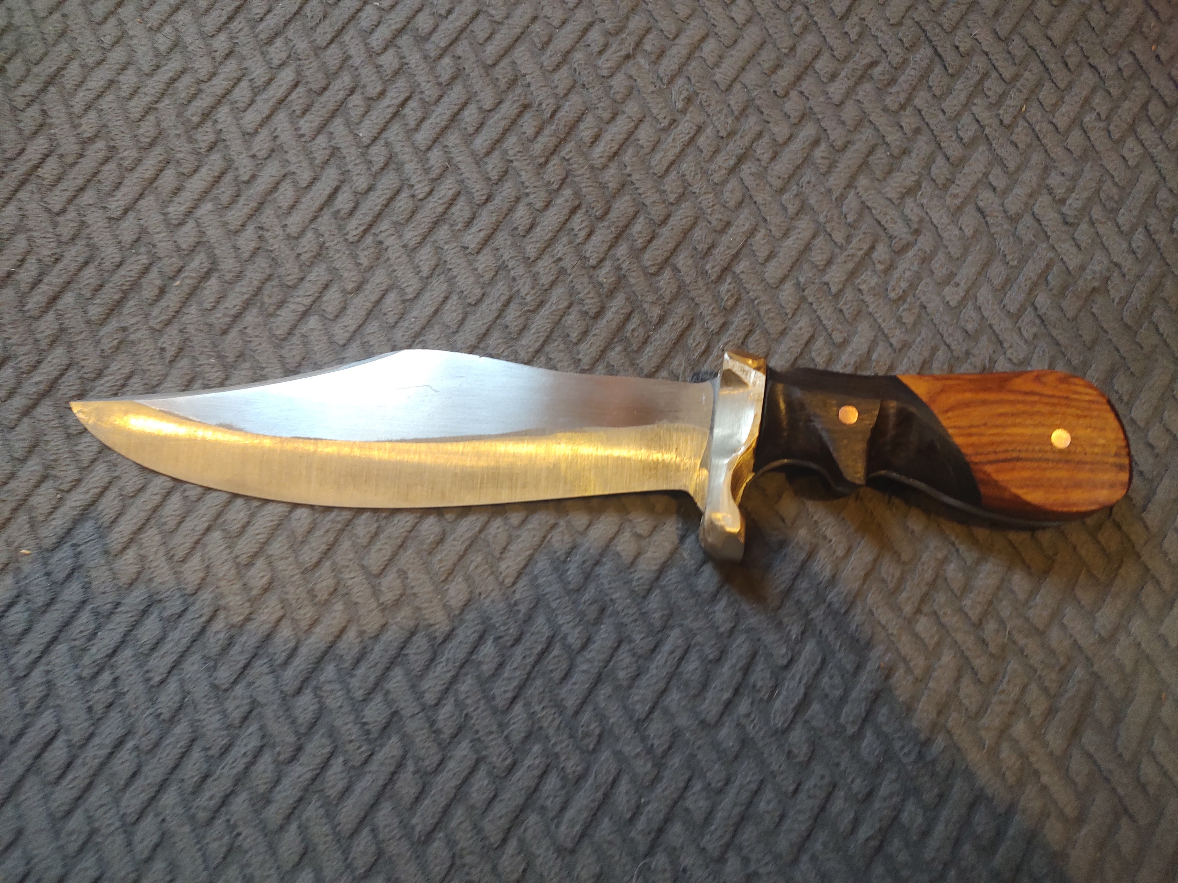 Hunting knife with brass guard and wooden handle