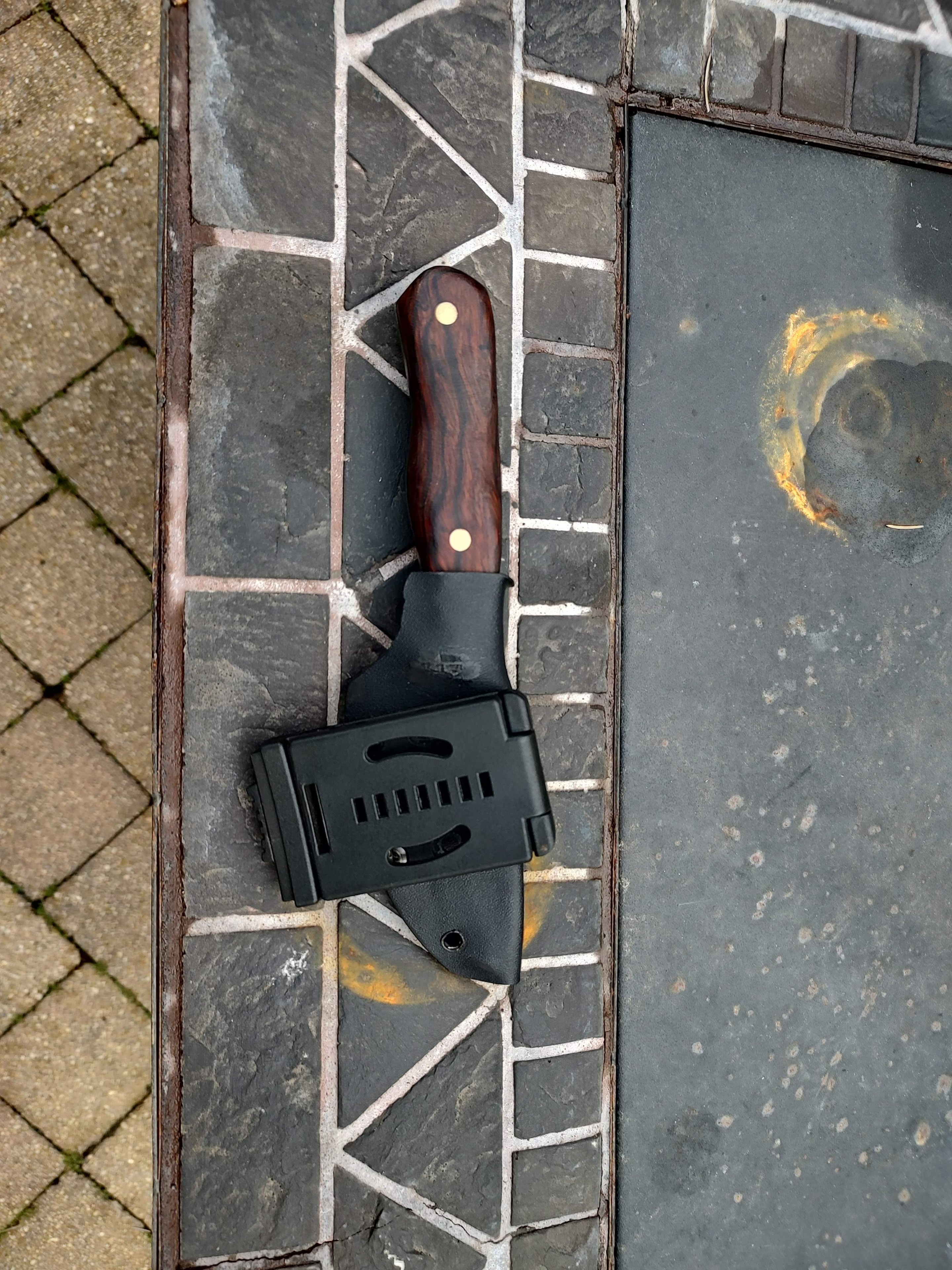 Chef knife with sheath on brick