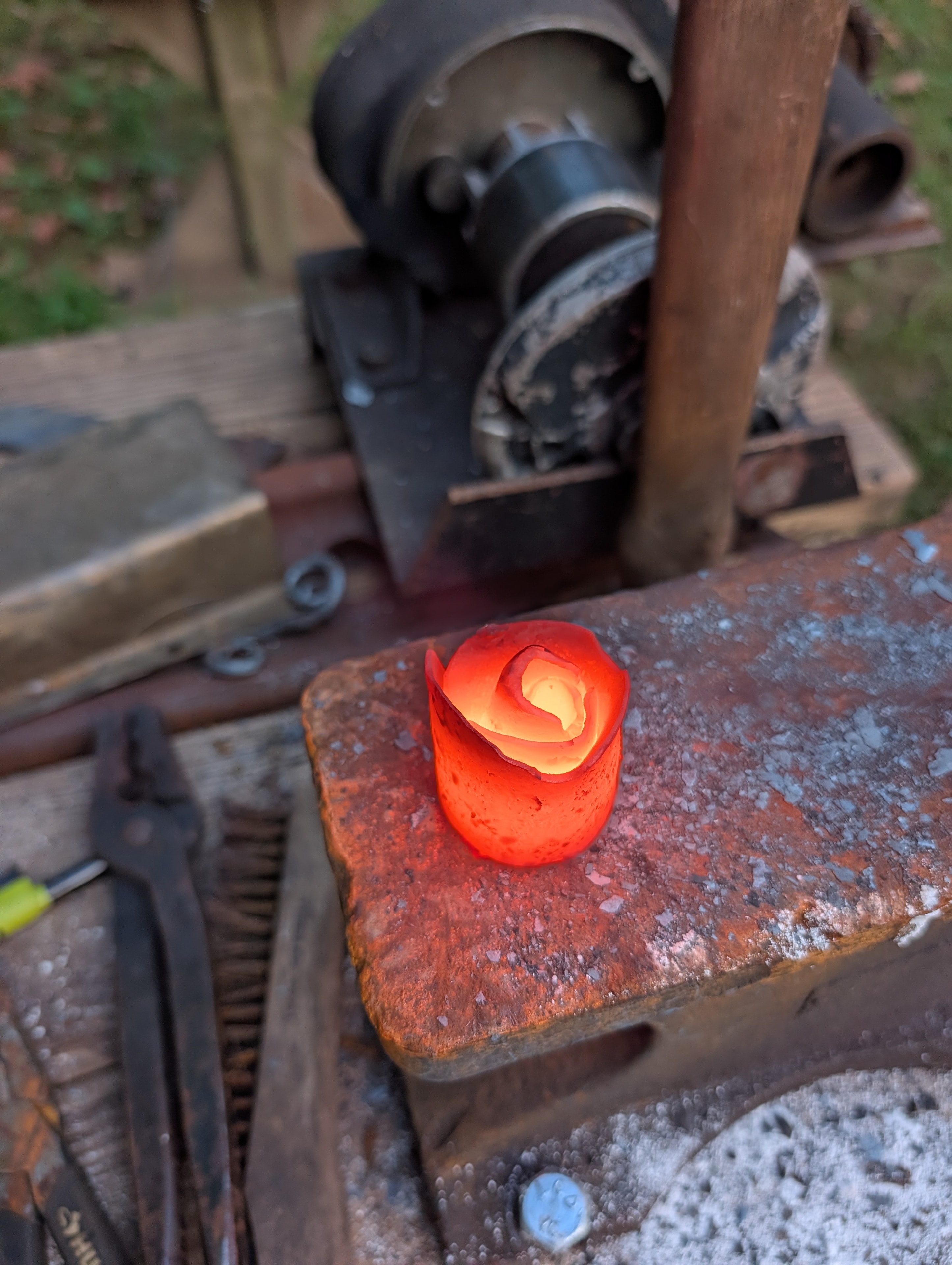 Glowing red metal rose fresh from the forge on the anvil