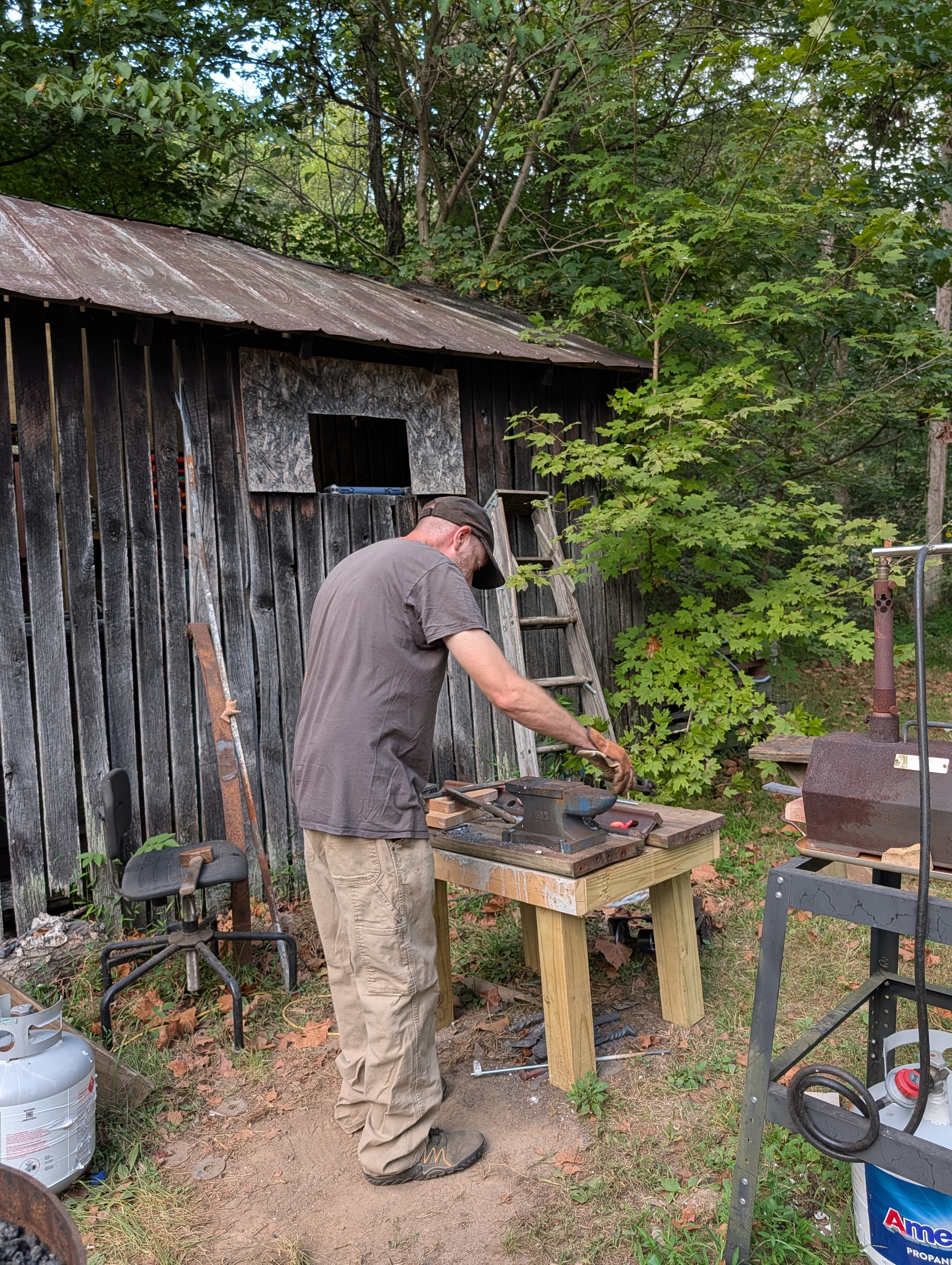Bsharp Blacksmith shaping steel at the outdoor anvil